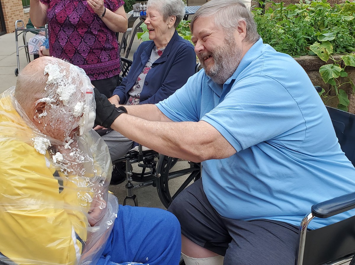 Residents putting pie in another resident's face